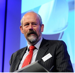 Image of Nick Buckland, stood at a podium with blue background